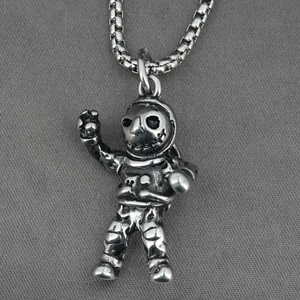 Punk style silver astronaut pendant with skull face on a square box chain necklace