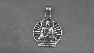 Macro detail of silver Buddha pendant showing lotus base and radiating halo textures