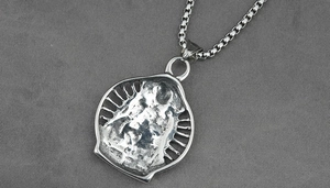 Detailed macro view of vintage titanium steel pendant with radial hollow carving design
