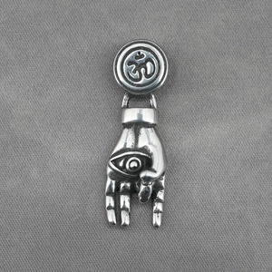 Titanium steel necklace with Om symbol and Evil Eye hand pendant on gray fabric