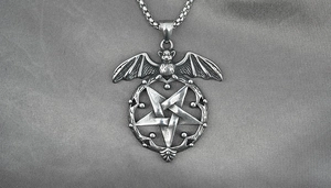 Close-up of gothic bat pendant with pentagram design on vintage silver stainless steel
