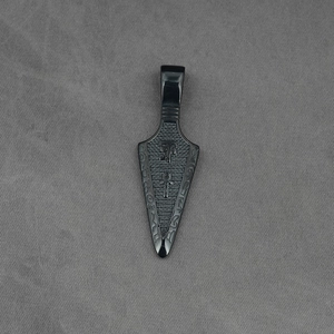 Vintage black stainless steel arrowhead pendant with embossed Ankh symbol on grey fabric