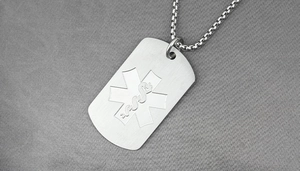 Macro shot of stainless steel medical alert dog tag with Star of Life engraving on box chain