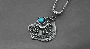 Detailed macro view of vintage titanium steel dog pendant with blue turquoise stone inlay