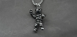 Macro shot of retro punk astronaut pendant necklace in polished titanium steel