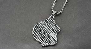 Macro shot of silver titanium necklace showing irregular bark texture and pearl chain