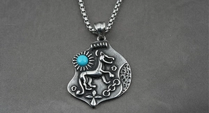 Detail of vintage silver titanium steel necklace featuring wolf totem and turquoise stone