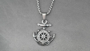 Detail of nautical anchor and rudder pendant with white rhinestones and vintage finish