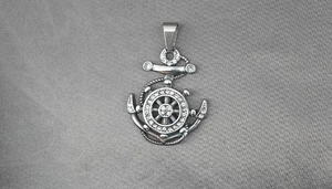 Detailed close-up of a silver anchor and helm pendant with sparkling white rhinestones