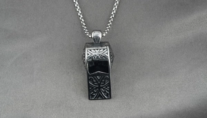 Detailed close-up of retro gothic engraved whistle pendant with a round box chain