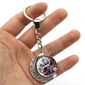 Yin Yang dragon moon keychain with rotating glass pendant and cherry blossom detail