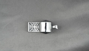 Macro detail of S925 sterling silver whistle pendant with cross engraving and hallmark