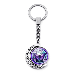 Porte-clés croissant de lune rotatif argenté avec pendentif papillon violet et bleu