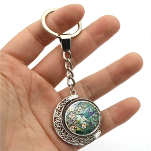 Porte-clés lune rotatif avec colibri en métal argenté et pendentif en verre