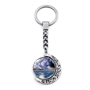 Silver celestial spinning moon keychain featuring a cosmic star nebula pattern