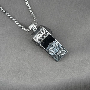 Vintage silver whistle pendant necklace with ornate floral patterns on a heavy square chain