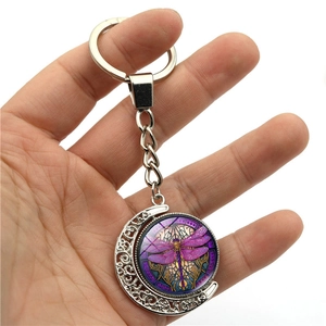 Portachiavi con ciondolo a luna rotante libellula viola e cornice in metallo argento