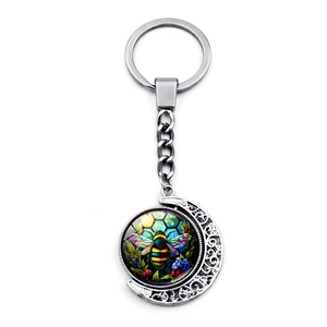 Rotating crescent moon keychain with colorful bumblebee glass pendant in vintage silver