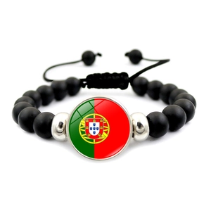 Close-up of matte black beaded Portugal flag bracelet with adjustable woven cord