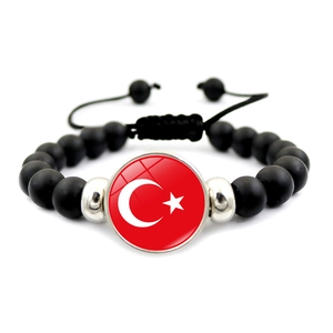 Detail of adjustable black beaded bracelet featuring the Turkish flag national emblem