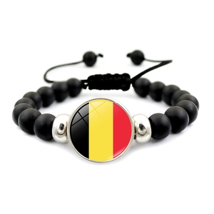 Detailed shot of black beaded bracelet with Belgium flag pendant and braided cord