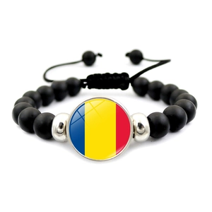 Detailed macro view of Romania flag charm on matte black stone beaded bracelet