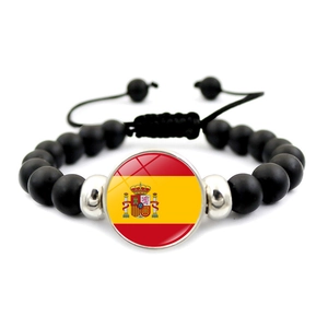 Adjustable black matte beaded bracelet featuring a round Spain flag charm with silver spacers