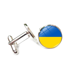 Close-up of Ukrainian flag cufflinks with polished silver finish and glass dome detail