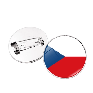 Detailed macro view showing the front flag design and silver pin back of the brooch