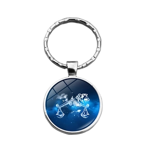 Detailed close-up of Libra zodiac keychain with deep blue galaxy pattern and silver finish