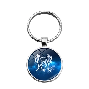 Silver Gemini zodiac keychain with blue starry sky and cosmic constellation pattern
