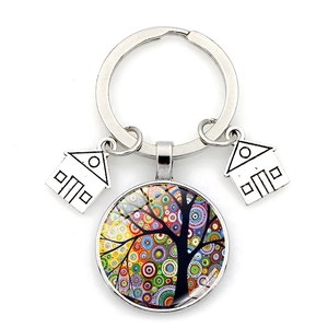 Detailed macro view of crystal glass tree of life keychain with alloy house pendants