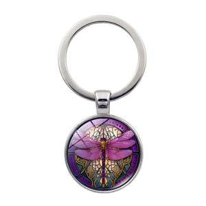 Detailed macro view of the silver metal keychain with purple dragonfly glass dome art