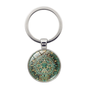 Silver Aztec sun stone calendar keychain with turquoise glass dome on white background