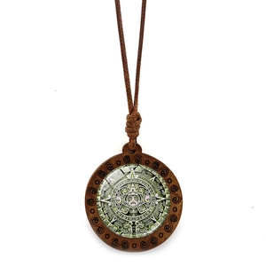 Vue détaillée du calendrier aztèque sur un pendentif rond en bois avec corde tressée