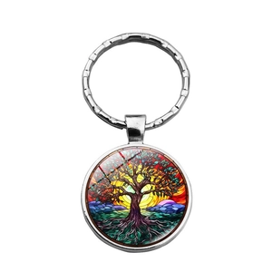 Polished metal Tree of Life keychain with colorful stained glass pattern on white background