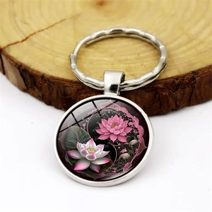 Yin Yang lotus flower glass cabochon keychain with silver alloy ring on wood