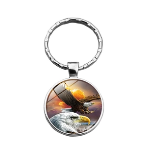 Silver metal keychain featuring a soaring American eagle design in a round glass pendant