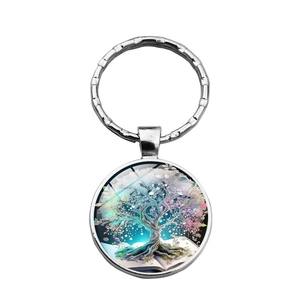 Tree of Life glass cabochon keychain with artistic book design on white background