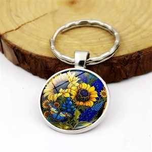 Porte-clés artistique en verre avec motif de tournesol et papillon sur pendentif argenté