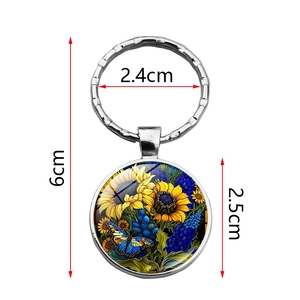 Porte-clés dôme en verre tournesol et papillon avec pendentif de 2,5 cm sur fond blanc