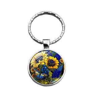 Porte-clés cabochon en verre avec tournesol et papillon bleu sur anneau en argent
