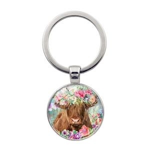 Silver highland cow keychain with floral crown glass pendant and polished metal ring