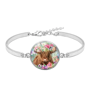 Silver Highland Cow bracelet with colorful floral crown and glass cabochon pendant