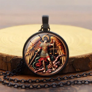 Detail of vintage St. Michael pendant necklace featuring colorful religious artwork