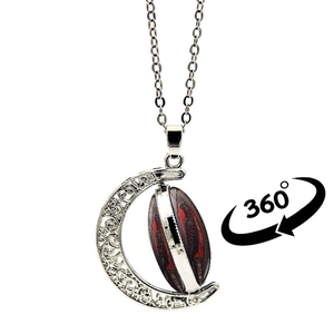 Detailed macro of vintage moon pendant with 360-degree rotating raven crow time gem