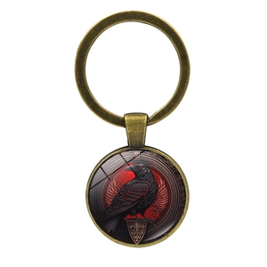 Macro shot of bronze raven pendant with gothic art pattern and round glass cabochon