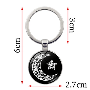Detailed view of luminous sun and moon keychain showing 6cm total length and 2.7cm pendant size