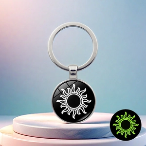 Luminous sun pattern keychain with glowing effect on marble base background