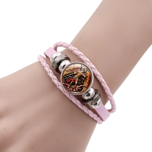Detail of multi-layer pink leather bracelet featuring Archangel Michael glass charm